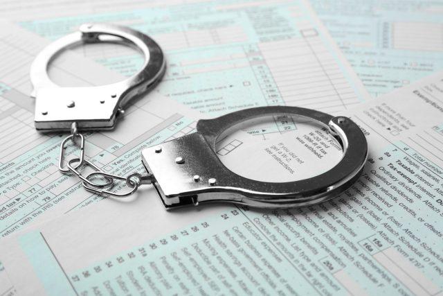 Handcuffs on income tax return form background